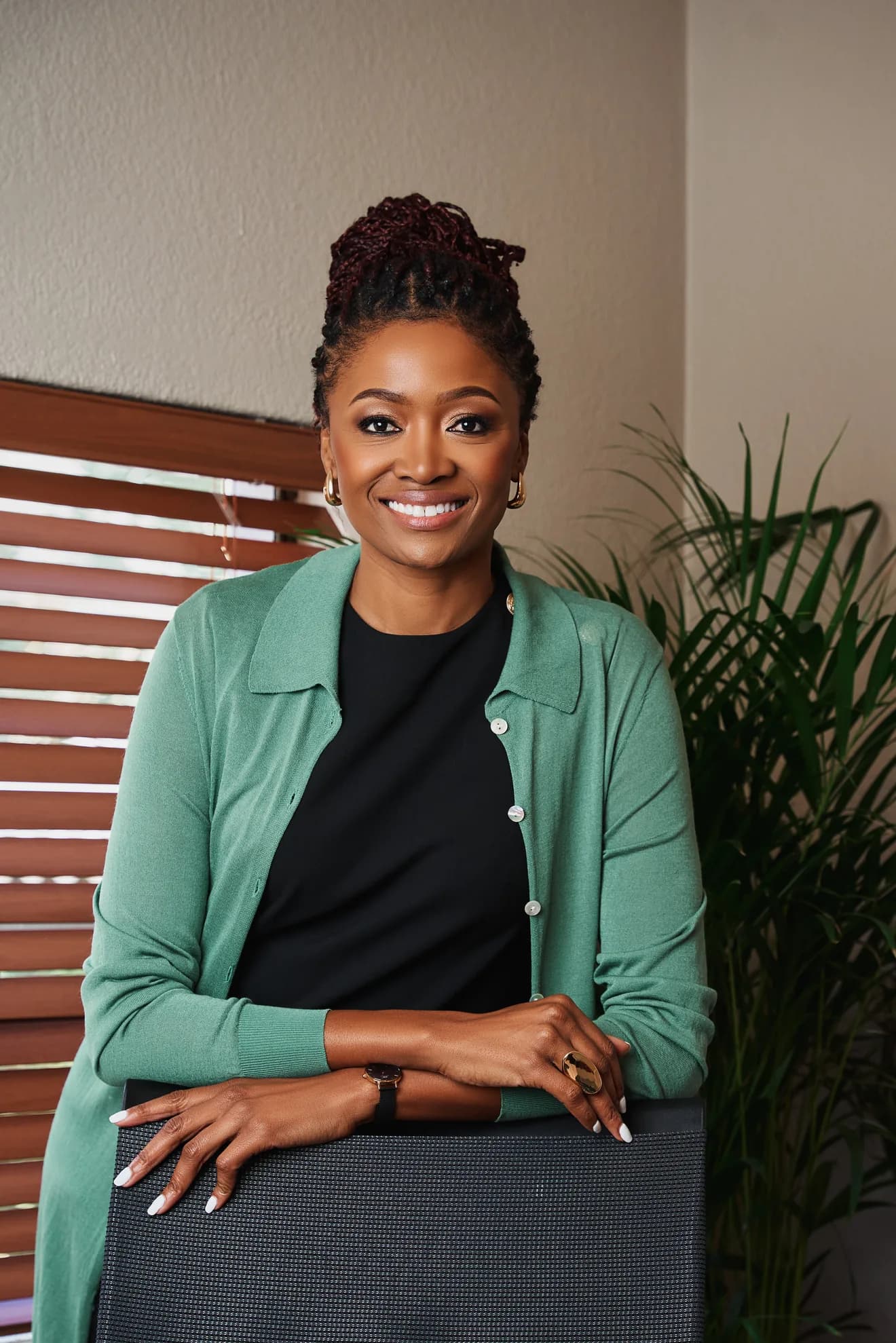 Ndumi Hadebe smiling in a green cardigan